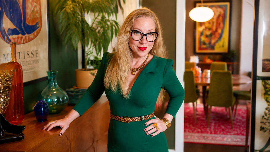 Sherry Martin standing beside a vintage floor mirror in a colorful mid-century-modern home