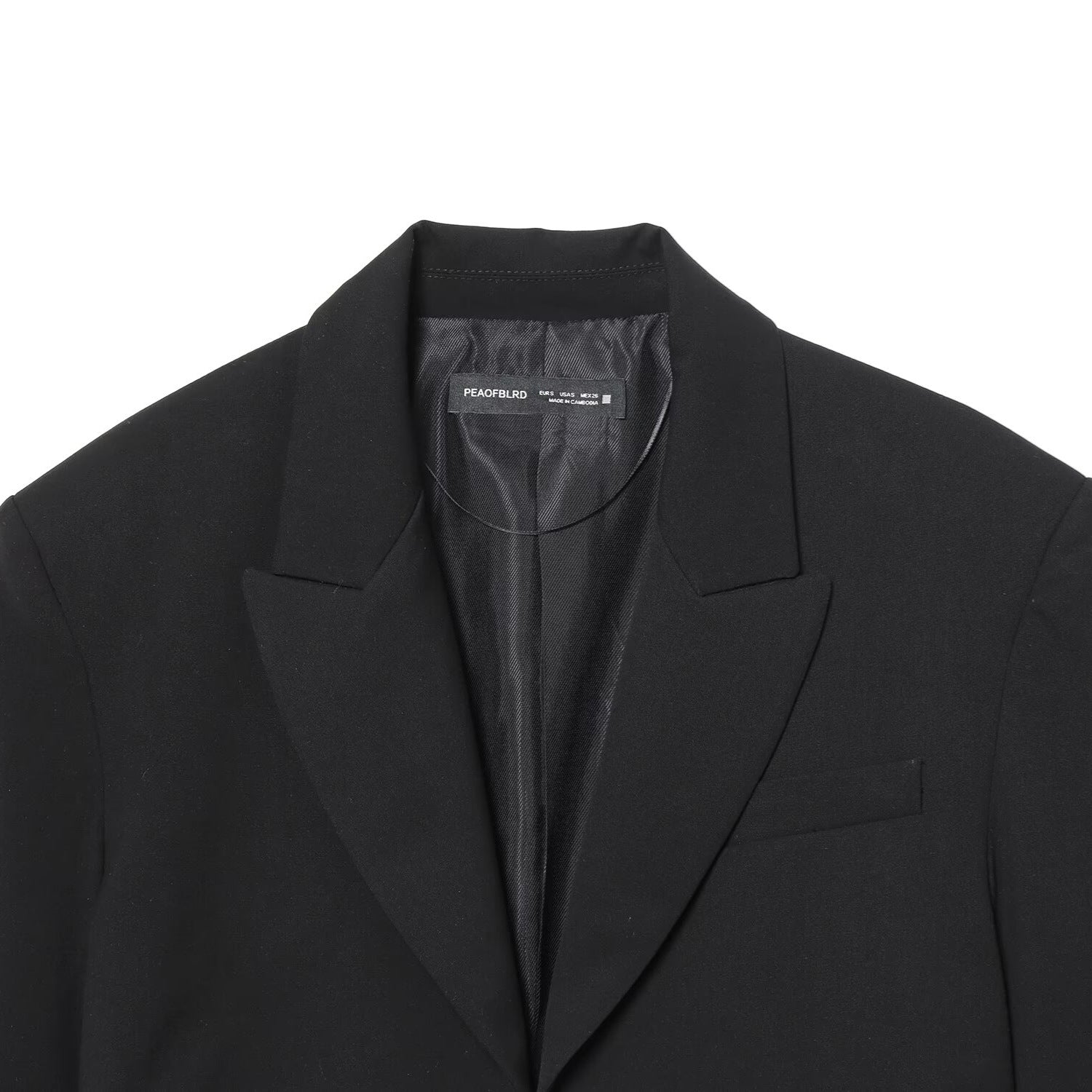 Black short suit jacket with shoulder pads and pleats