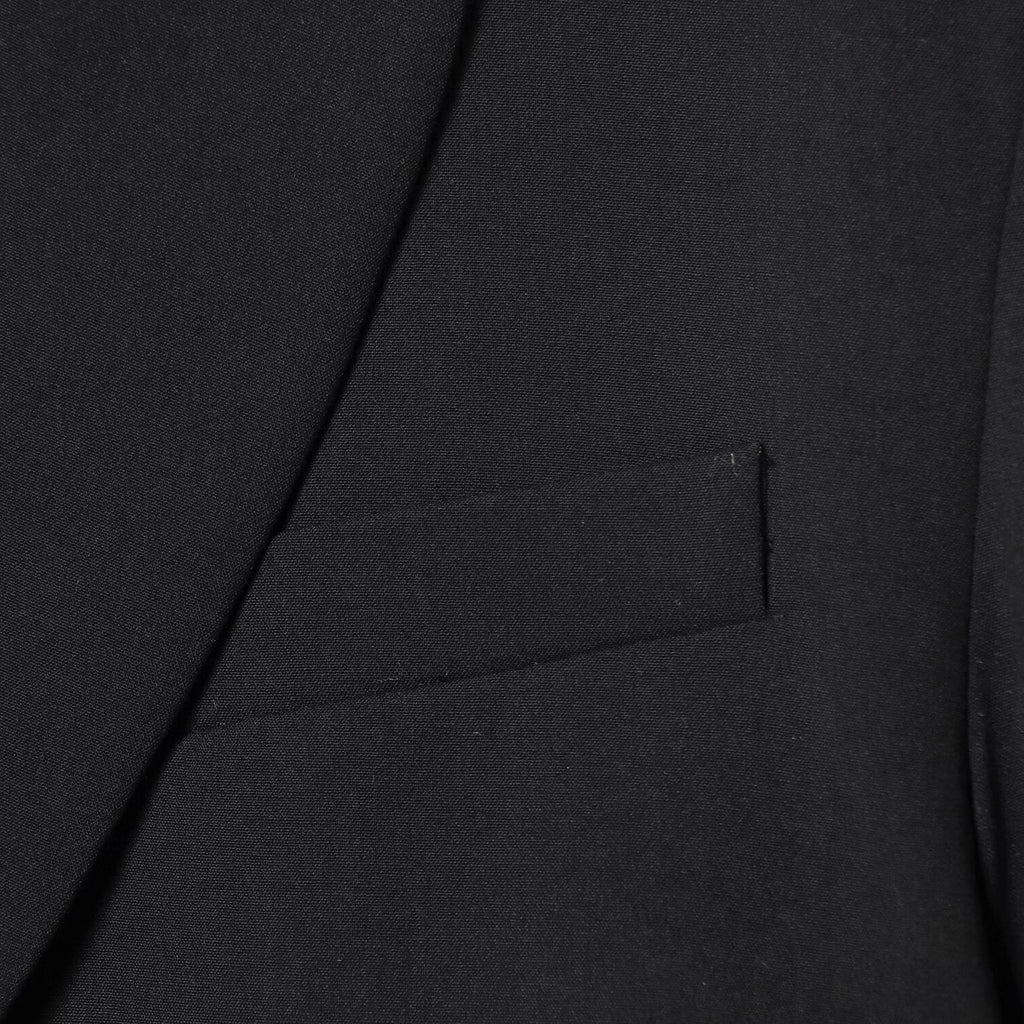 Black short suit jacket with shoulder pads and pleats
